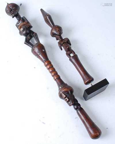* A prestige staff, carved as a female figure with tooth to ...