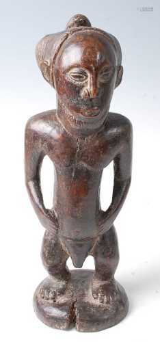 * A male ancestor figure in standing pose, with palm oil lib...