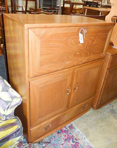 An Ercol elm Windsor fall front writing cabinet, width 82cm,...