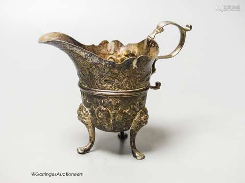 An 18th century Irish? silver cream jug, with later embossed...