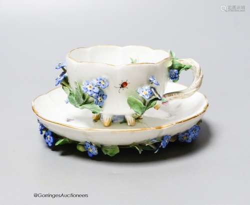 A 19th century Meissen floral encrusted cabinet cup and sauc...