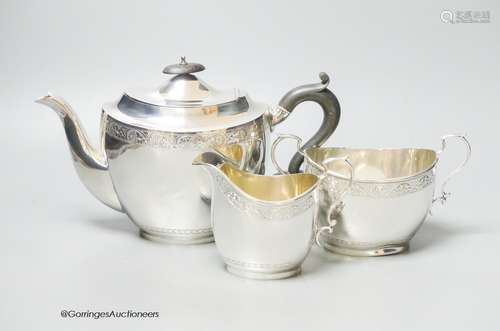 A George V three piece engraved oval silver tea set, C.S. Gr...