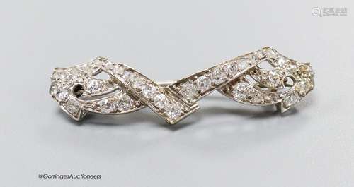 A white metal and diamond cluster set shaped bar brooch, 38m...