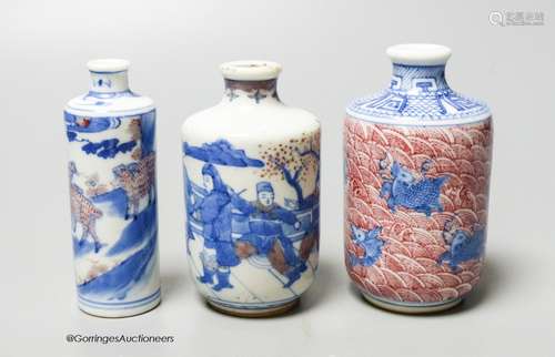 Three Chinese underglaze blue and copper red snuff bottles, ...