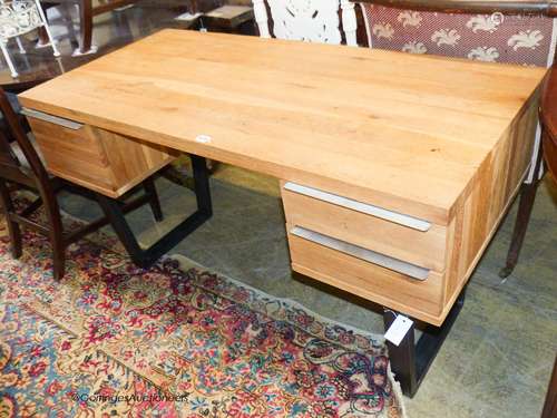 A contemporary black metal and oak kneehole desk, length 135...