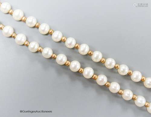 A modern single strand cultured pearl and yellow metal space...