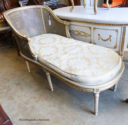 A Louis XVI style painted, giltwood and caned daybed (faults...