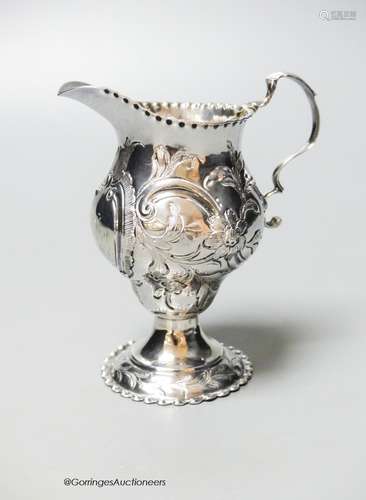 A George III silver helmet cream jug, with later embossed de...