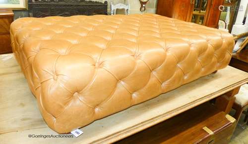 A large Victorian style buttoned tan leather footstool, leng...