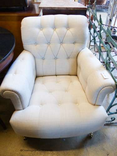 A Laura Ashley armchair upholstered in buttoned natural fabr...