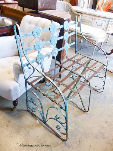 An early 20th century painted wrought iron garden bench, len...