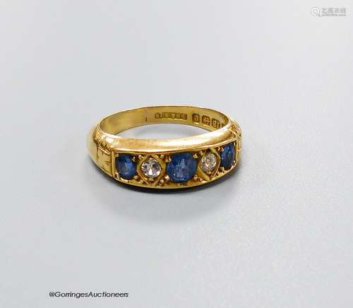 An Edwardian 18ct gold three stone sapphire and two stone di...