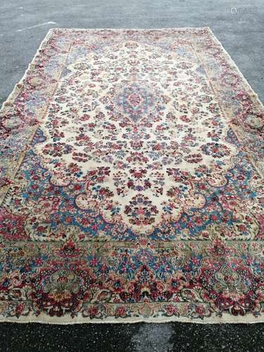 A large Tabriz ivory ground floral carpet, 500 x 300cm