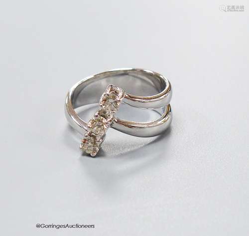 A modern white metal and three stone diamond set twin shank ...