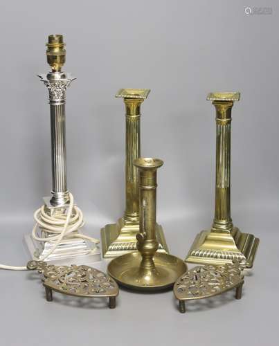 A pair of brass candlesticks, a telescopic candlestick and a...