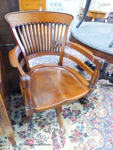 A late Victorian walnut revolving desk chair, width 58cm, de...