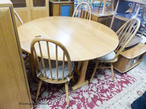 An Ercol elm circular drop leaf dining table, 126cm diameter...