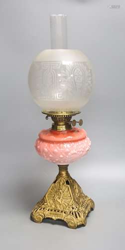 A Victorian cranberry glass and gilt metal oil lamp, with tw...