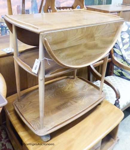 An Ercol elm drop flap three tier tea trolley, length 73cm, ...