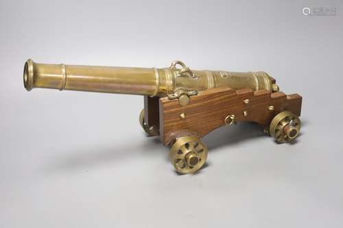 A 20th century bronze model cannon on wooden base, overall l...