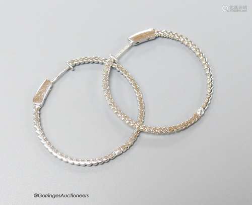 A modern pair of 18ct white gold and diamond chip set hoop e...