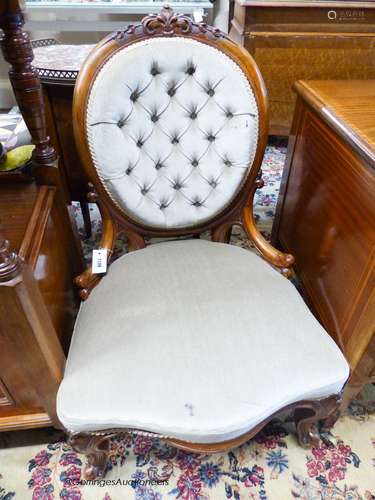 A Victorian walnut spoon back nursing chair upholstered in b...