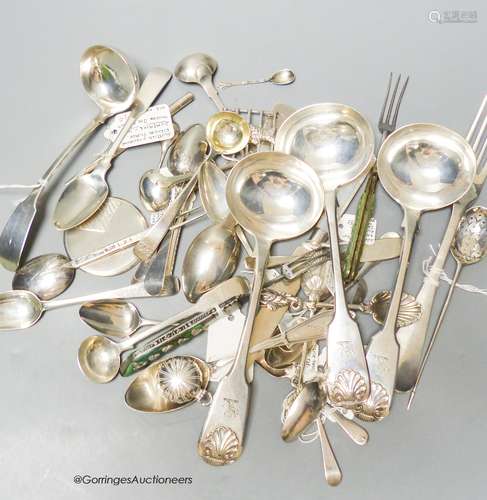 A mixed collection of silver and white metal spoons and othe...