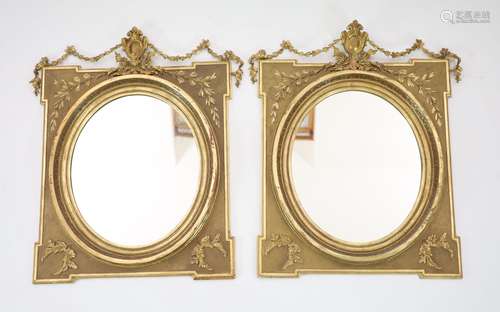 A pair of giltwood wall mirrors, of square form with oval pl...