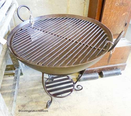 A wrought iron garden fire pit on stand with grill, diameter...