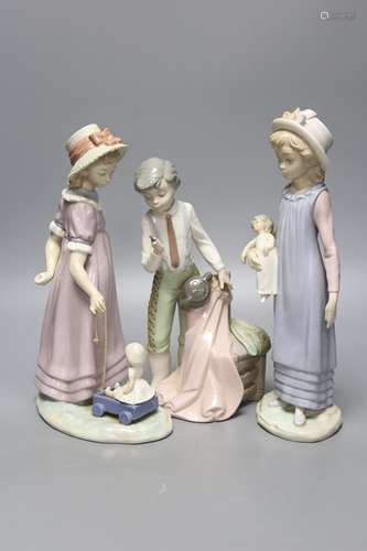 A Lladro figure of a girl with a doll, another girl with a d...