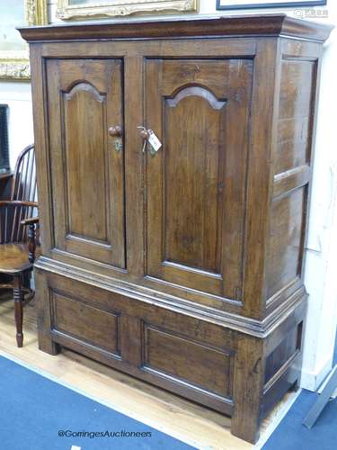 An early 18th century oak cupboard fitted a pair of arched f...