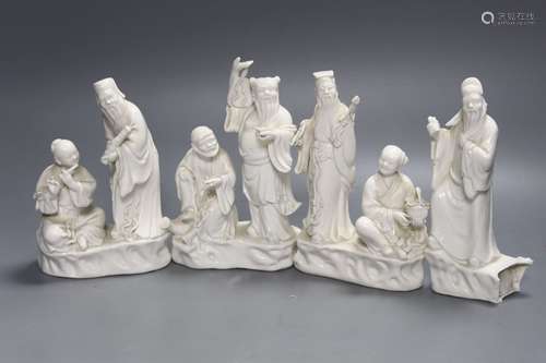 Three Chinese white porcelain groups of deities and a fragme...