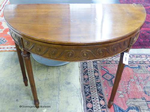 A George III style mahogany demi-lune card table. W-92, D-46...