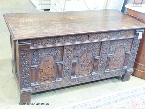 An 18th century marquetry inlaid oak coffer, width 130cm, de...