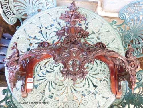 A carved mahogany bed canopy in the style of Thomas Chippend...