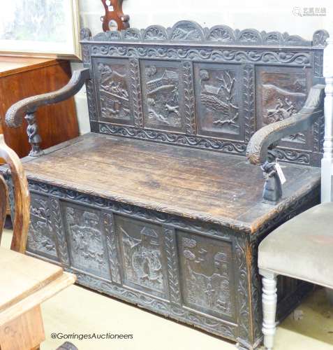 A late 19th century Flemish carved oak box seat settle, W.14...