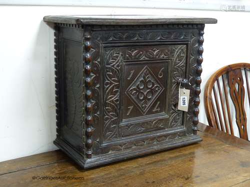 A Charles II carved oak wall cupboard (possibly Dorset),of r...