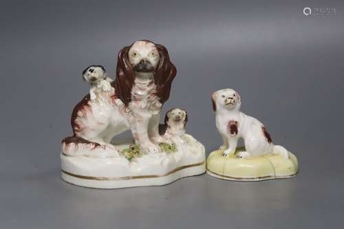 A Victorian Staffordshire Spaniels group and a small porcela...