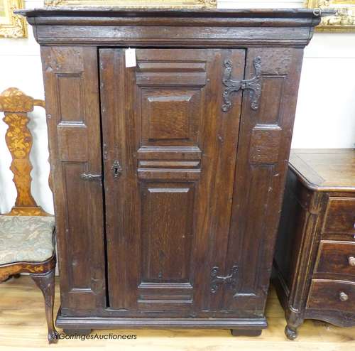 A 17th century German oak cupboard fitted a fielded panelled...