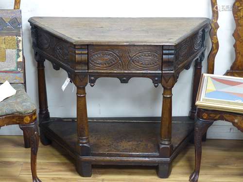 A 17th century carved oak credence type table (faults), widt...