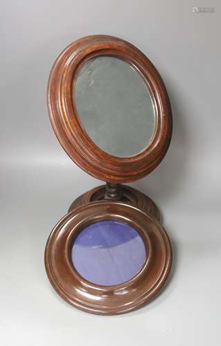 An oval mahogany-framed pedestal shaving mirror and circular...