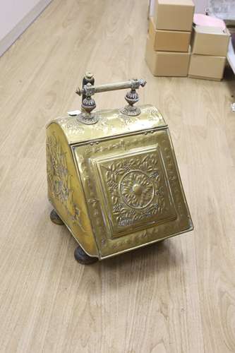 A Dutch embossed brass coal scuttle