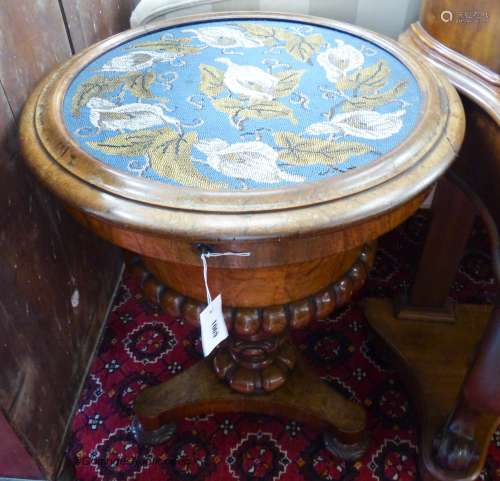 A Victorian walnut work table with circular hinged beadwork ...