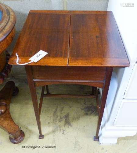 An Edwardian mahogany work table, with twin hinged flap top,...