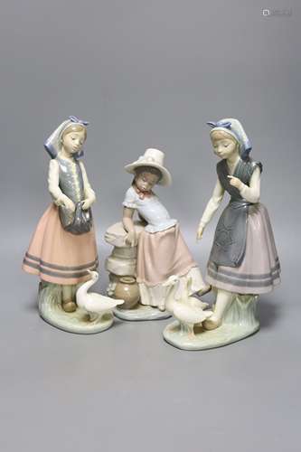 A Lladro figure of a girl feeding a duck, another sitting on...