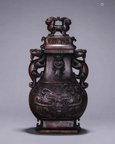A taotie patterned aloeswood vase with dragon shaped ears