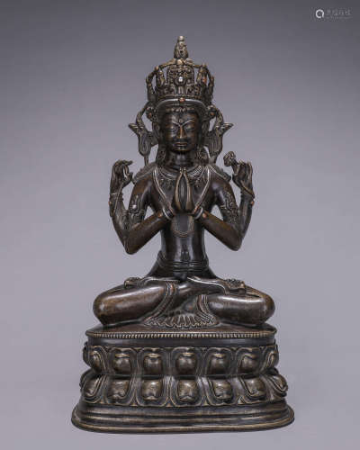 A copper silver-inlaid four-armed Guanyin bodhisattva