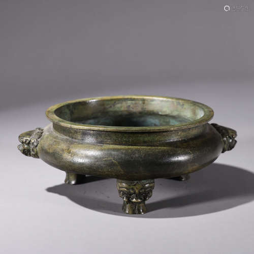 A copper censer with lion head shaped ears