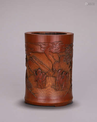 A carved bamboo brush pot