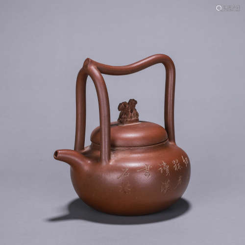 A carved zisha ceramic loop-handled pot